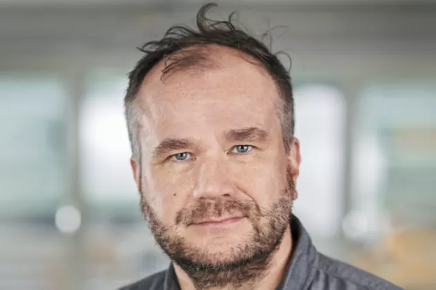Portrait photograph of Markus Lahtinen. Bright background. 